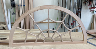 Arched spider web transom sash